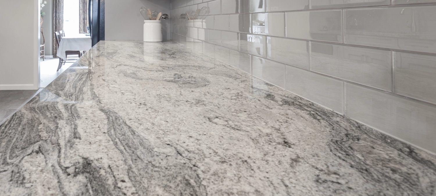 1-close-up-image-of-a-modern-kitchen-showing-a-sealed-granite-countertop-meeting-a-subway-tile-backsplash
