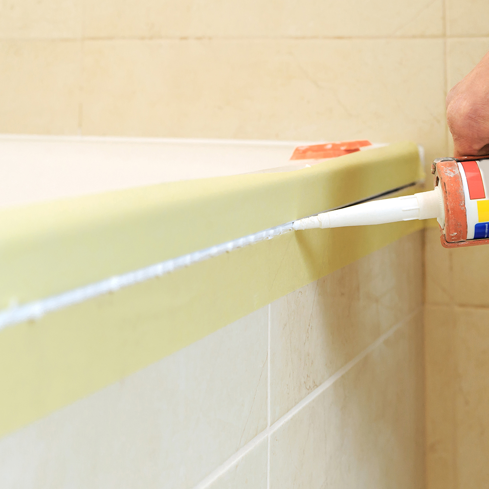 Worker Puts Silicone Sealant.